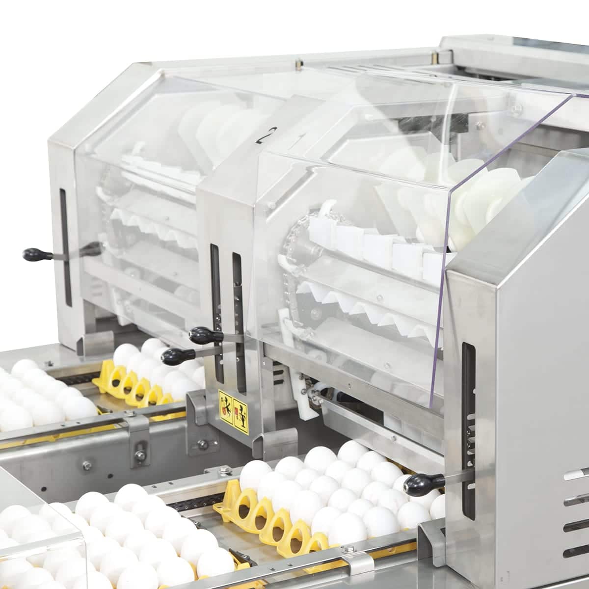 Stainless steel egg processing machine with clear plastic covers, designed for sorting and handling eggs.