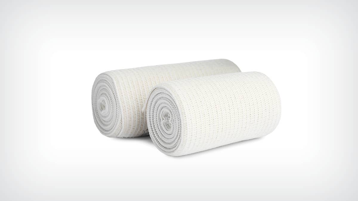 Two rolls of white, elastic bandage material against a light grey background.